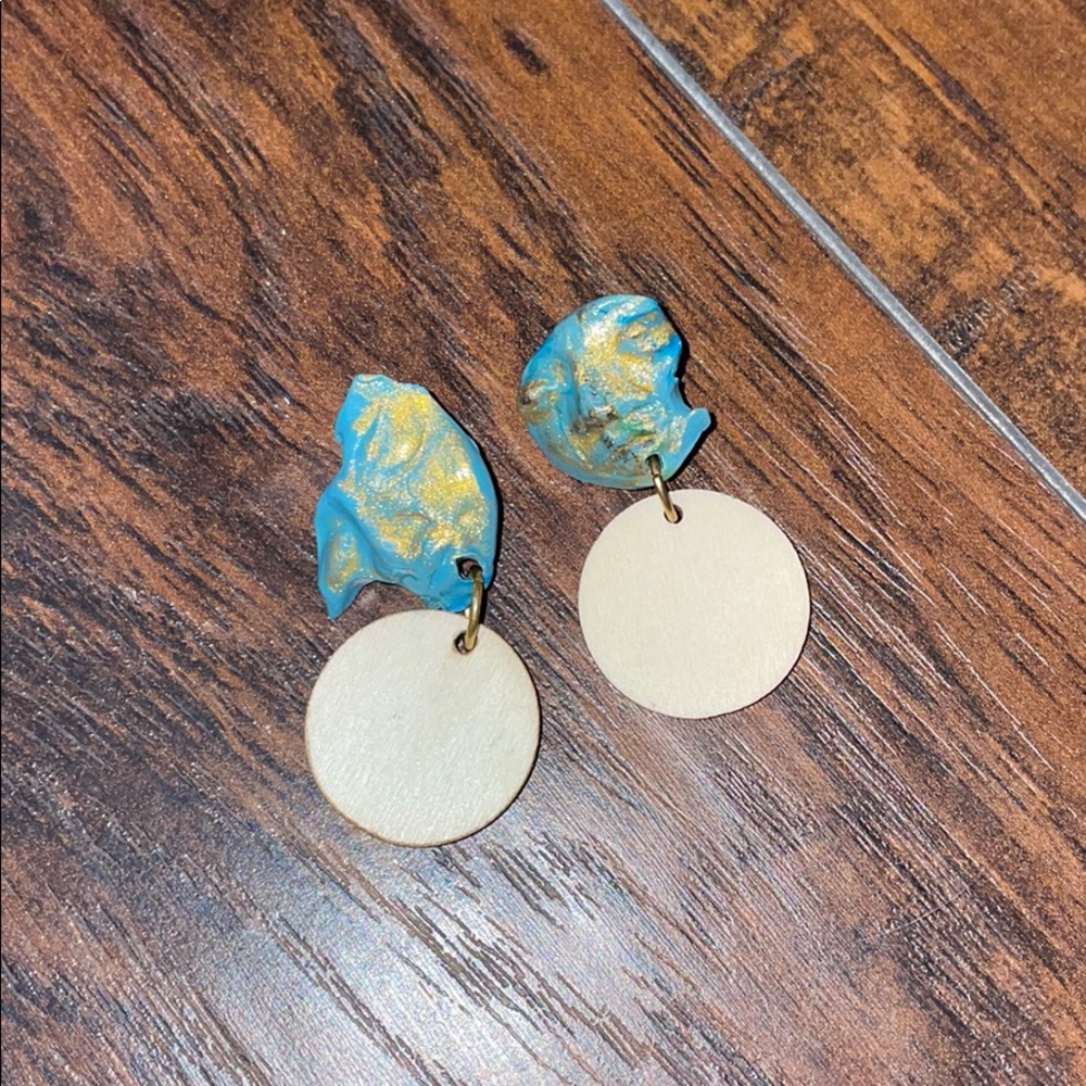Custom earrings. Clay mask with wood.